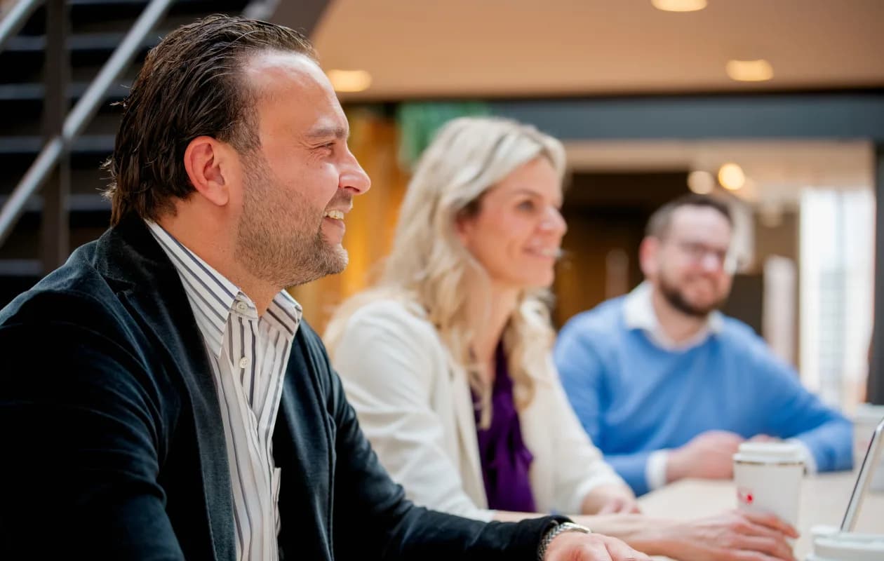 Three people talking in the office
